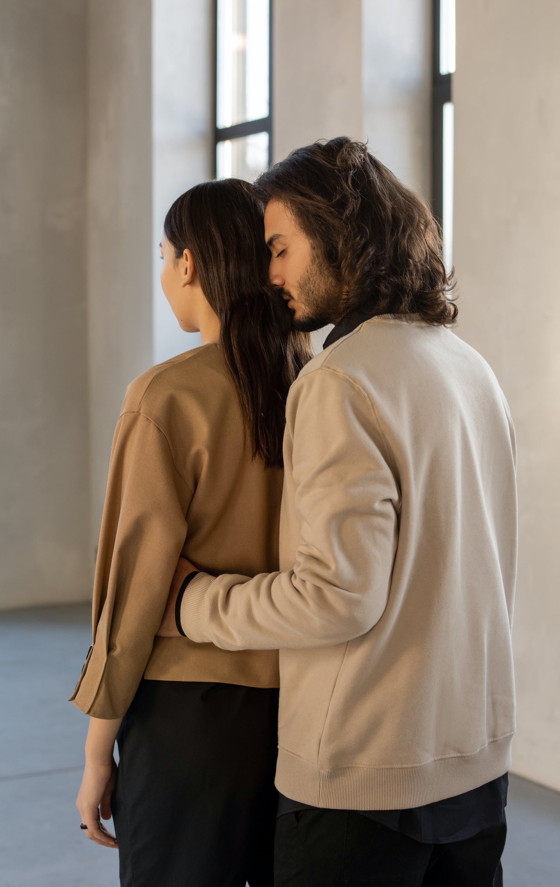 A man hugging a woman from behind